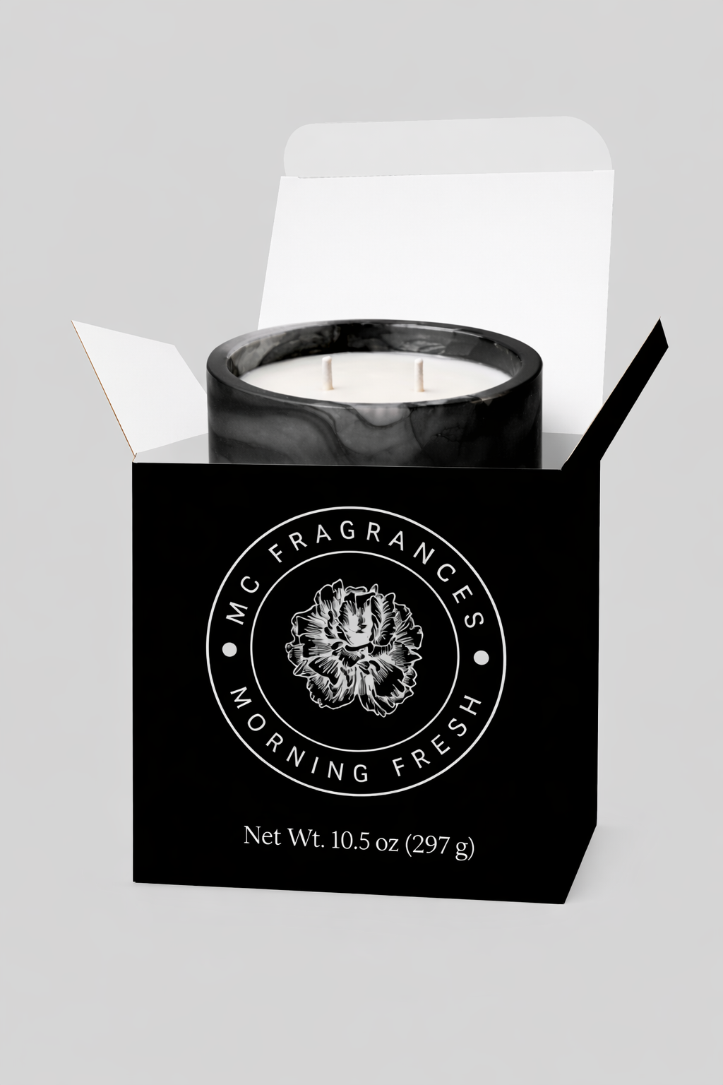 Candle in a black box with 'M.C. Fragrances' branding on a gray background