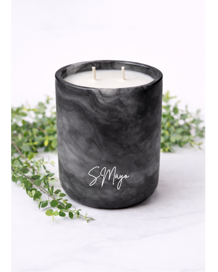 Black marbled candle with 'S. Mayo' branding on a white background