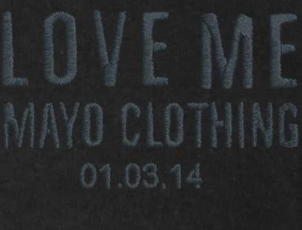 Text 'LOVE ME MAYO CLOTHING 01.03.14' embroidered on black hoodie.